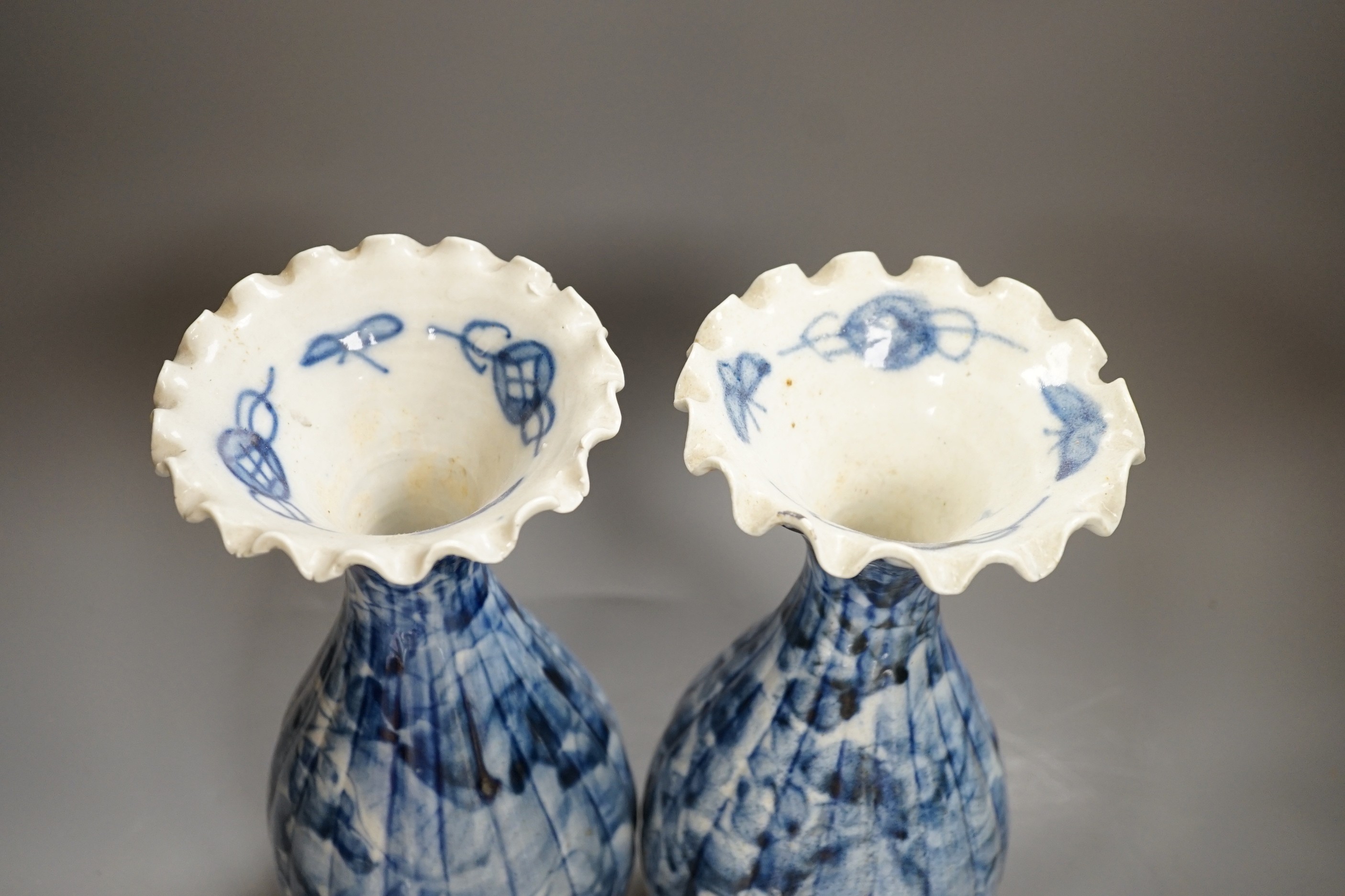 A pair of early 20th century Japanese fluted blue and white flared rim vases, 31.5cm